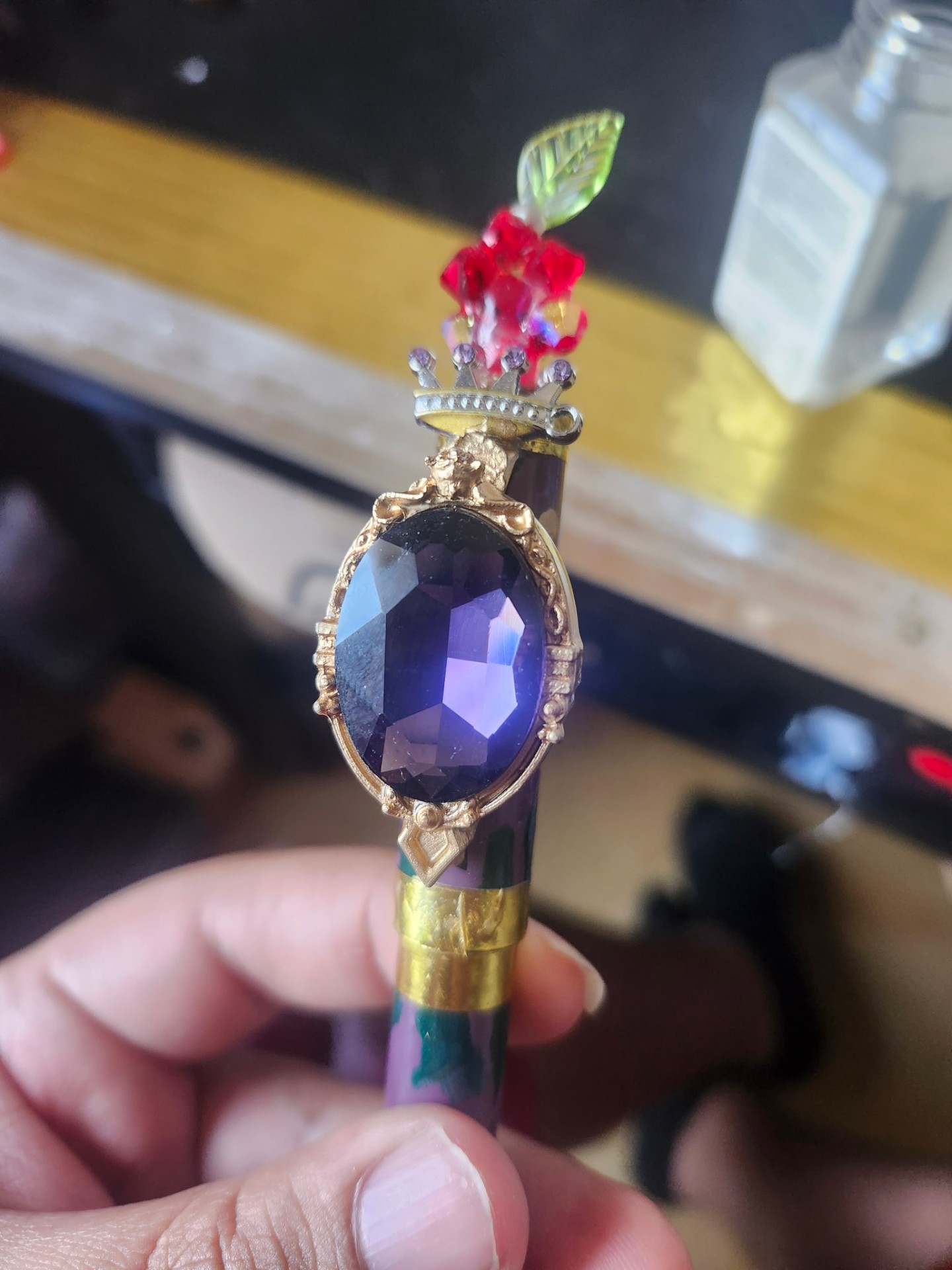 Hand-painted gem holder with rose-and-crown topper, purple gem