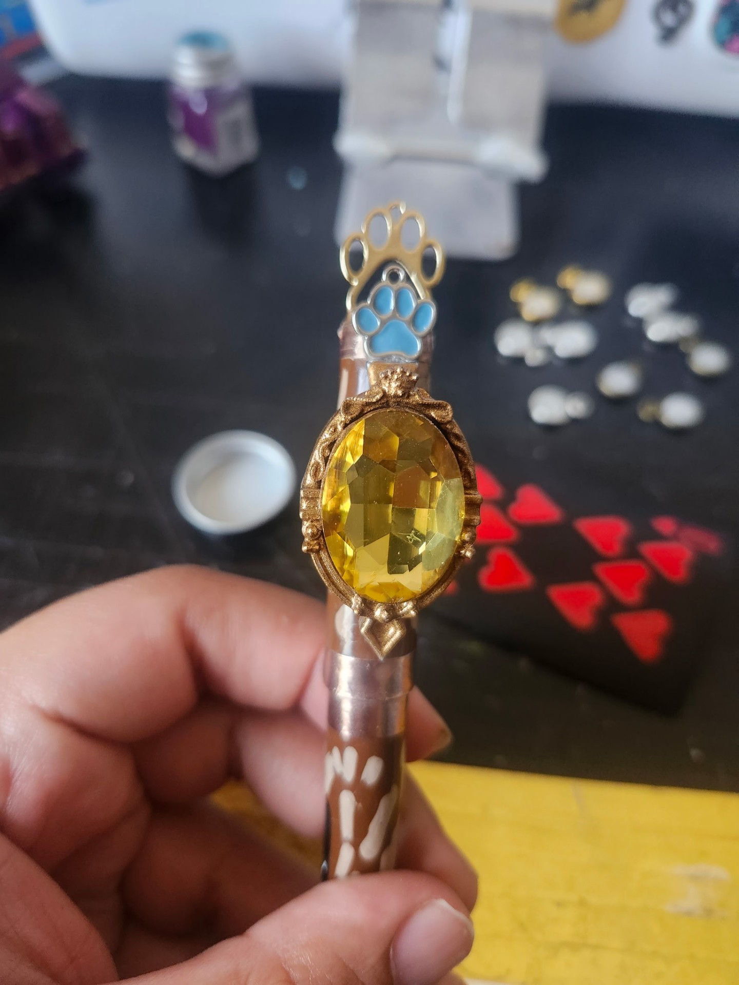 Hand-painted gem holder with paw-print topper, yellow gem
